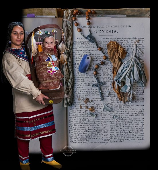 Native American woman holding child against a backdrop of the Bible