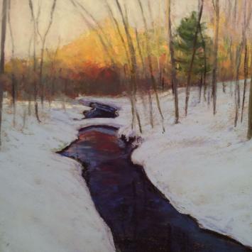 Image of a creek flowing through a quiet snowy wood