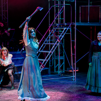 Character of Lizzie Borden wielding an axe in production of Lizzie, the Musical, taken by Jim Sabitus