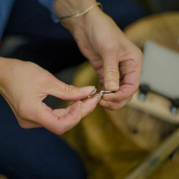 Hands making jewelry