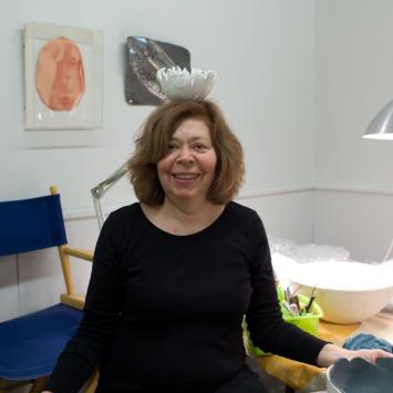 Tina Forbes in the studio Ceramic artist with ceramic bowl on her head