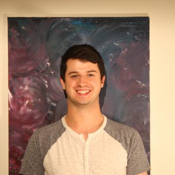 Man standing in front of a painting