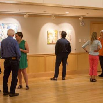 People looking at paintings in a gallery